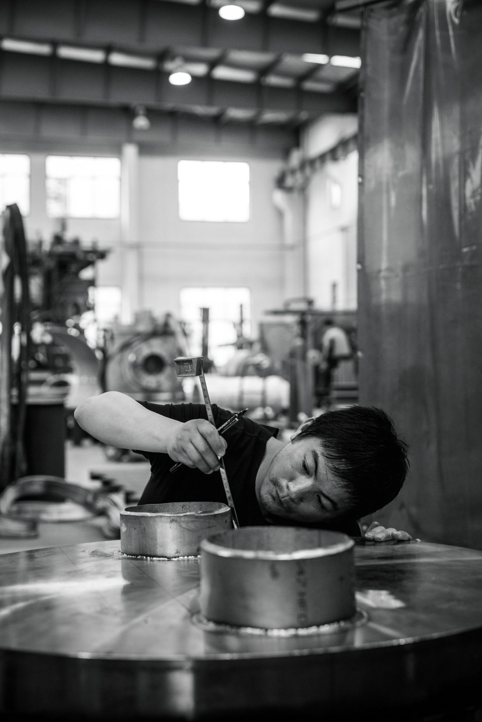 Welder Cai Guo Dong measuring a unit under production in Vahterus assembly plant in Zhangjiangang, China.